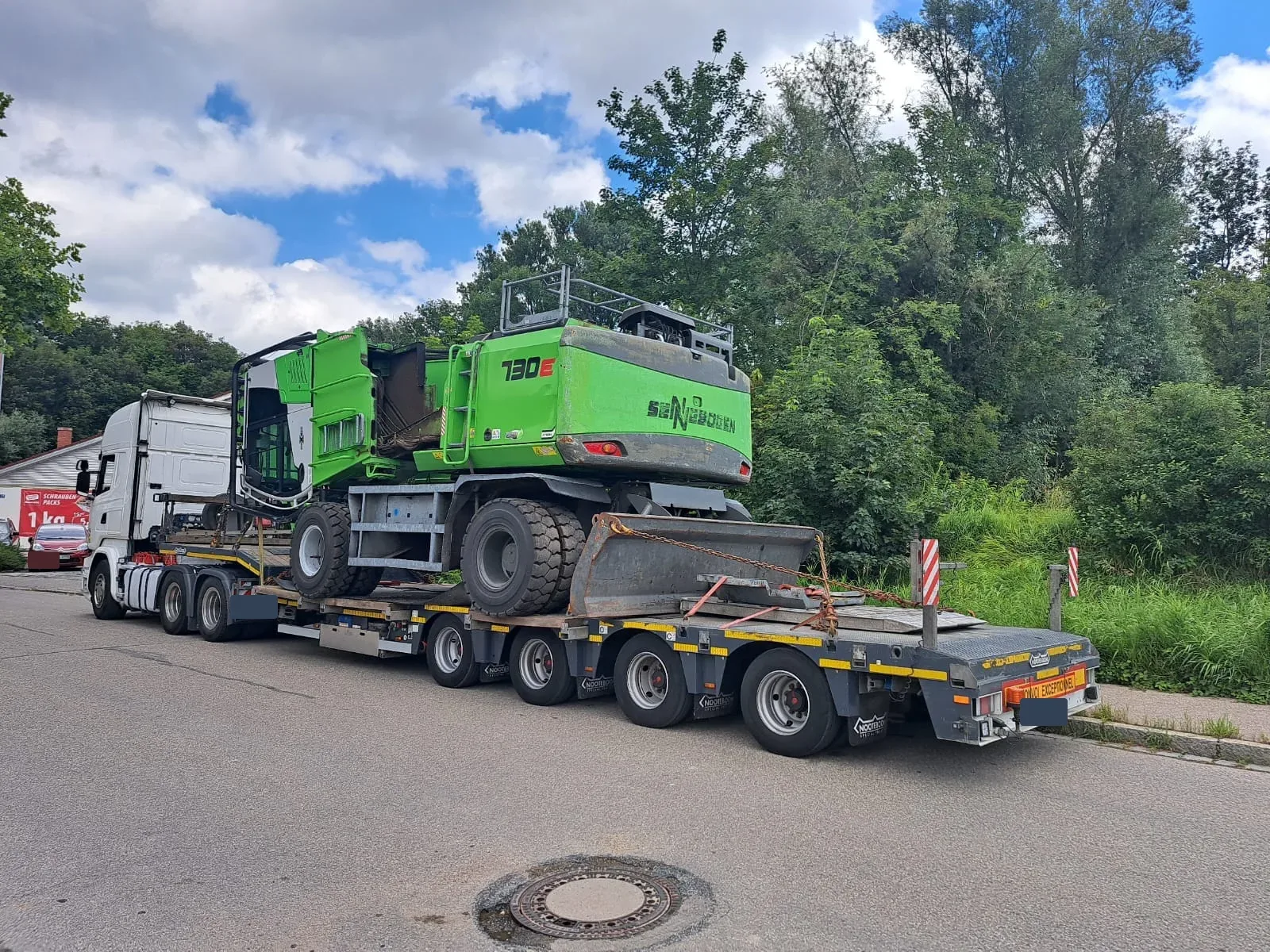 Maszyna przeładunkowa Sennebogen 730E na 4-osiowej naczepie Nooteboom Gonera Transport