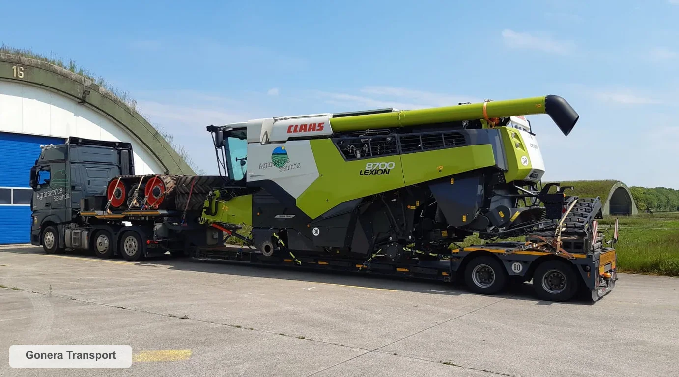 Transport kombajnu zbożowego na naczepie niskopodwoziowej z wózkiem hedera Gonera